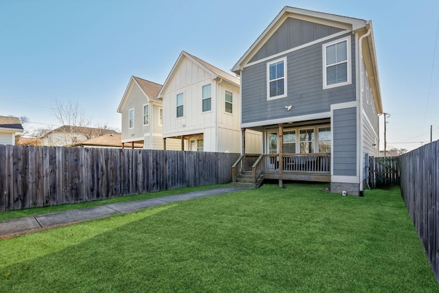 back of house featuring a yard