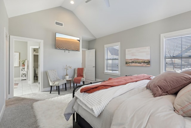 carpeted bedroom featuring lofted ceiling, connected bathroom, and ceiling fan