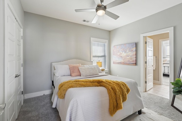 bedroom featuring carpet floors, connected bathroom, and ceiling fan