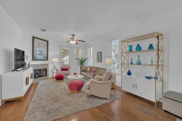 living room with wood-type flooring and ornamental molding