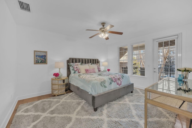 bedroom featuring access to exterior, light hardwood / wood-style flooring, and ceiling fan