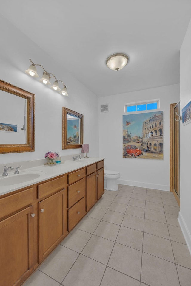 bathroom with toilet, tile patterned flooring, and vanity