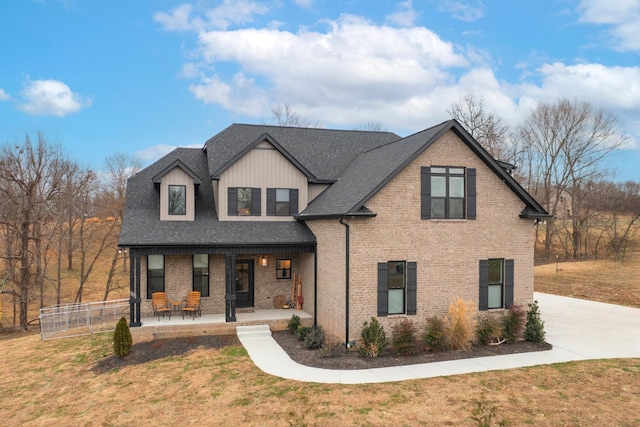 view of front of home featuring a front yard and a porch