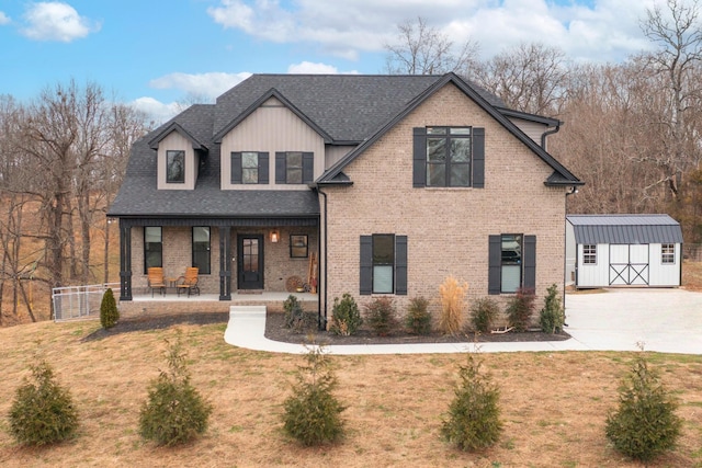 view of front of house featuring a front lawn, a porch, and a storage unit