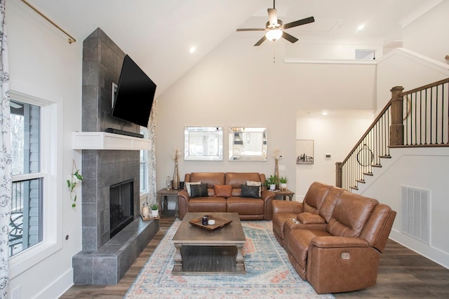 living room with high vaulted ceiling, dark wood-type flooring, and a healthy amount of sunlight