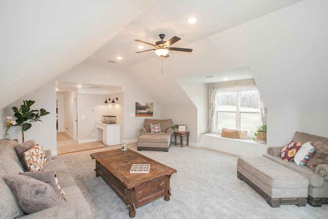 carpeted living room featuring ceiling fan and lofted ceiling