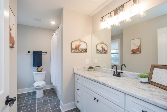 bathroom featuring toilet and vanity