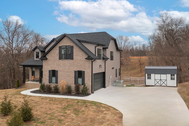 view of home's exterior with a garage, a yard, a storage shed, and a porch