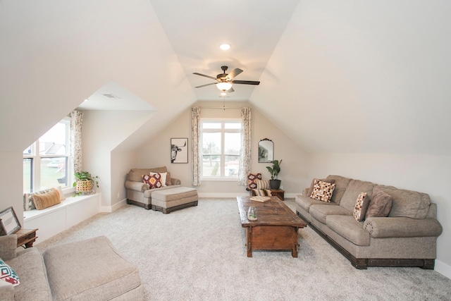 carpeted living room featuring ceiling fan and vaulted ceiling