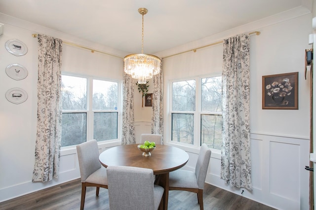 dining room featuring ornamental molding, plenty of natural light, and dark hardwood / wood-style flooring