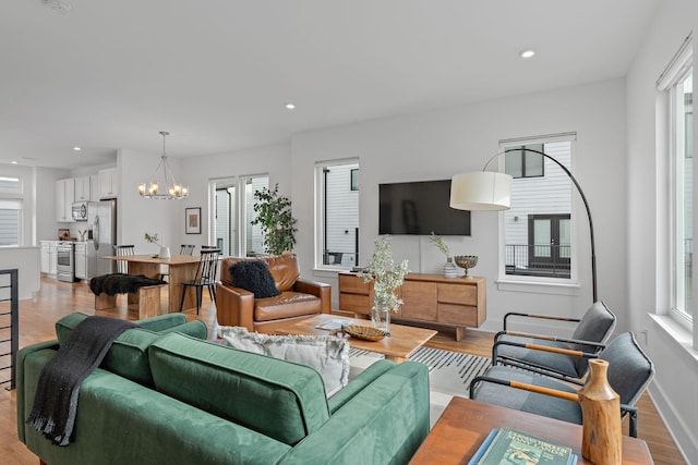 living room with a chandelier and light hardwood / wood-style floors