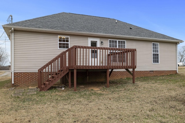 back of property featuring a deck and a lawn