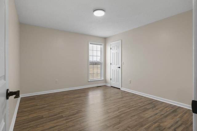 empty room featuring dark hardwood / wood-style floors