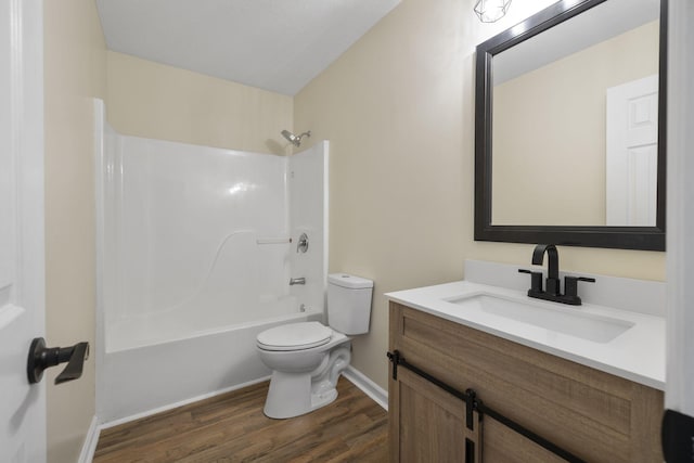 full bathroom with tub / shower combination, hardwood / wood-style flooring, toilet, and vanity