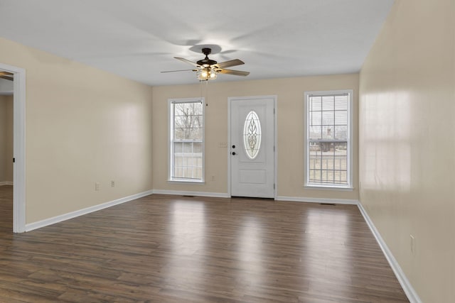 foyer entrance with ceiling fan and dark hardwood / wood-style flooring