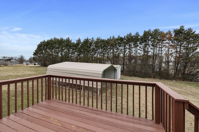 wooden deck featuring a lawn