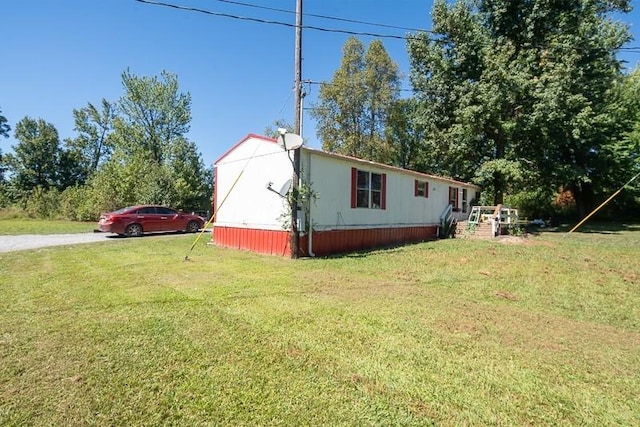 view of side of home with a lawn