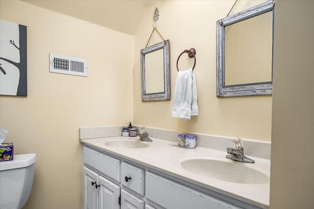 bathroom featuring toilet and vanity