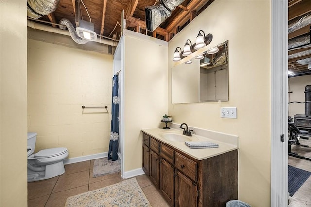 bathroom featuring vanity, toilet, and tile patterned flooring