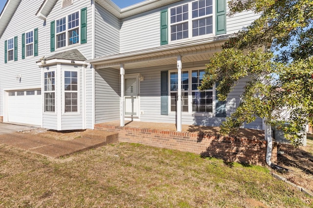 exterior space featuring a garage and a lawn