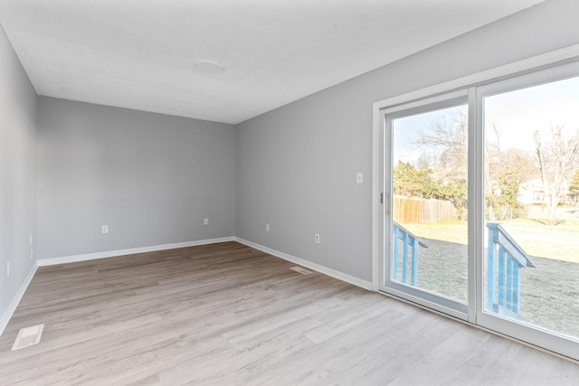 spare room featuring light wood-type flooring