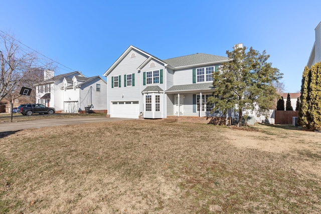 view of front facade featuring a garage and a front lawn