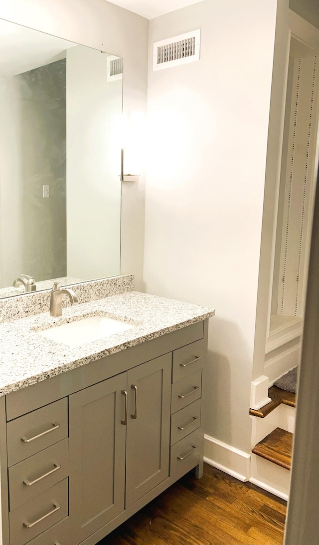 bathroom with vanity and hardwood / wood-style floors