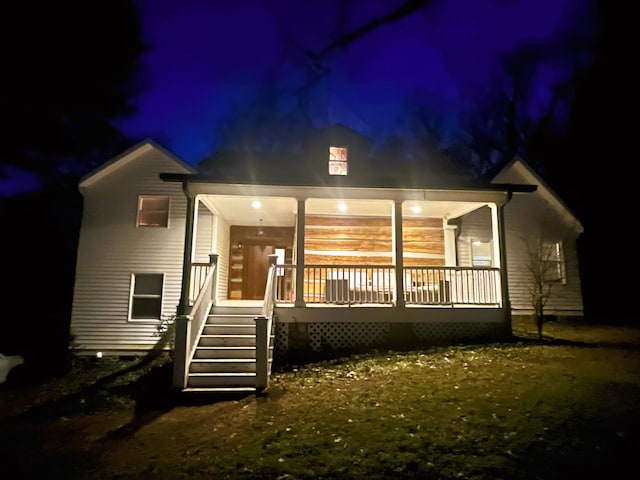 view of back house at twilight