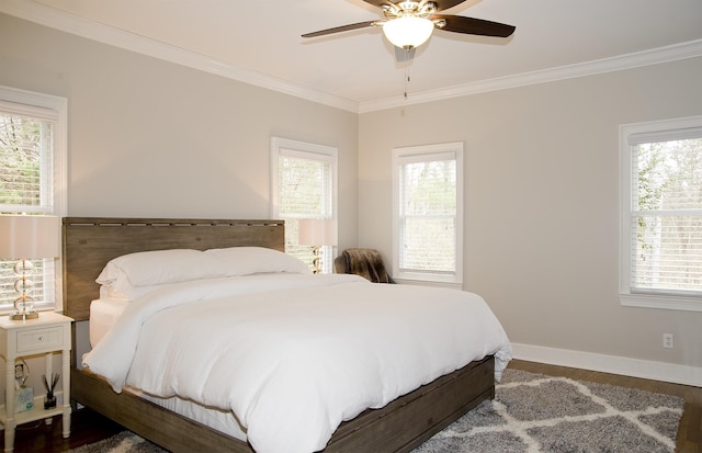 bedroom featuring ceiling fan, ornamental molding, hardwood / wood-style floors, and multiple windows