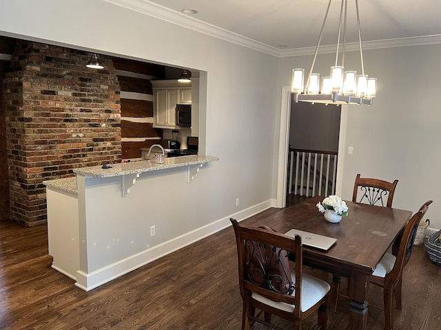 dining area featuring an inviting chandelier, ornamental molding, and dark hardwood / wood-style flooring