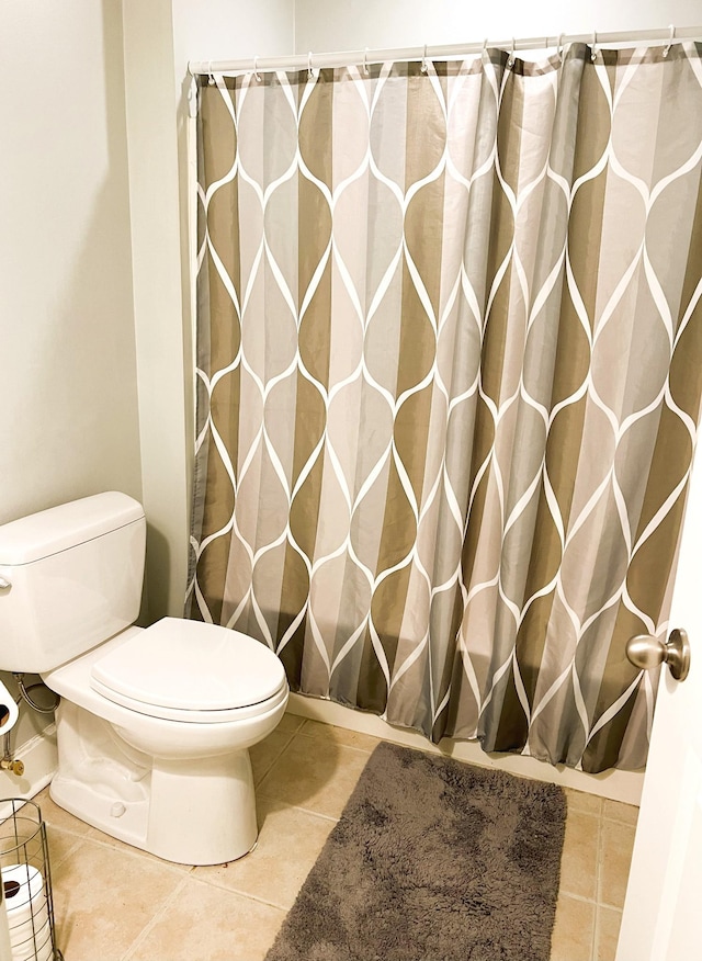 bathroom with tile patterned flooring and toilet