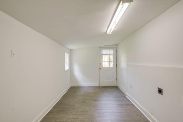 interior space with vaulted ceiling and wood-type flooring