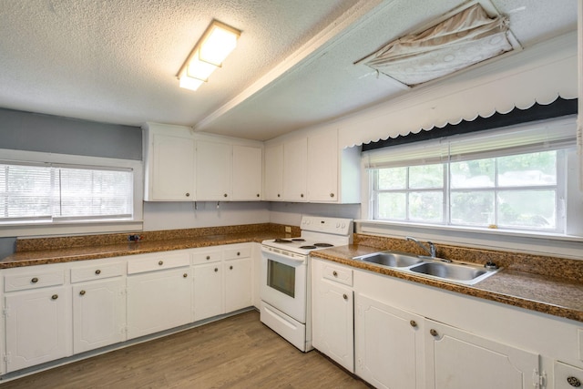 kitchen with white cabinets, white electric stove, and sink