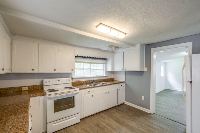 kitchen with sink, light wood-type flooring, white cabinets, white appliances, and a textured ceiling