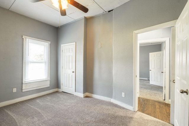 unfurnished bedroom featuring carpet flooring and ceiling fan