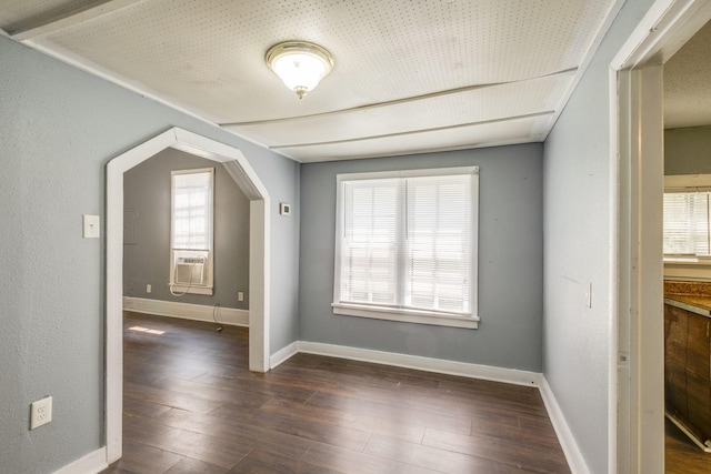 additional living space featuring cooling unit and dark hardwood / wood-style flooring