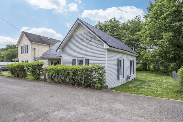 view of side of home with a lawn