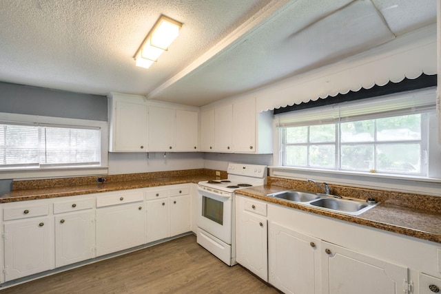 kitchen with white cabinets, sink, and white range with electric stovetop