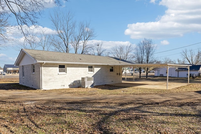 exterior space featuring central AC and a carport