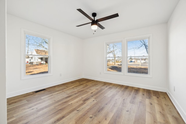 empty room featuring ceiling fan and light hardwood / wood-style flooring