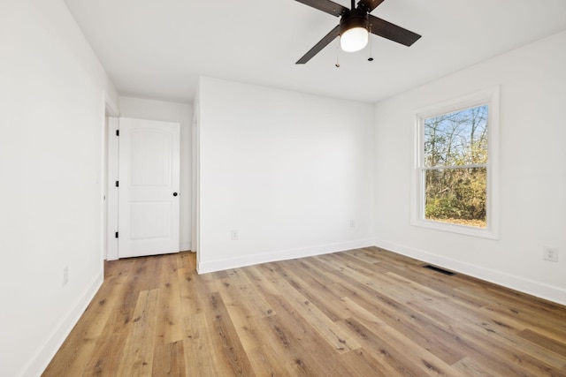 empty room with light hardwood / wood-style floors and ceiling fan