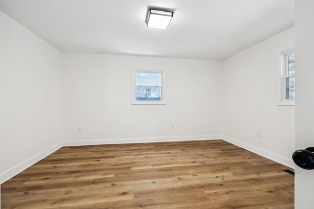 spare room with hardwood / wood-style flooring