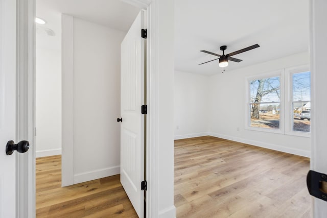 spare room with light hardwood / wood-style floors and ceiling fan