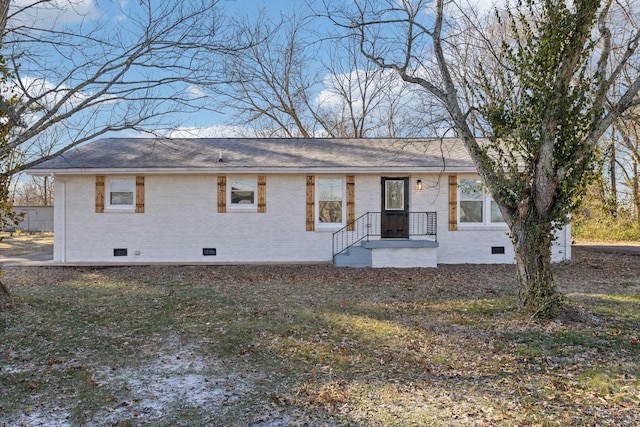 rear view of house with a yard