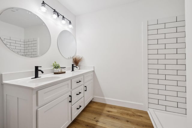 bathroom with hardwood / wood-style flooring and vanity