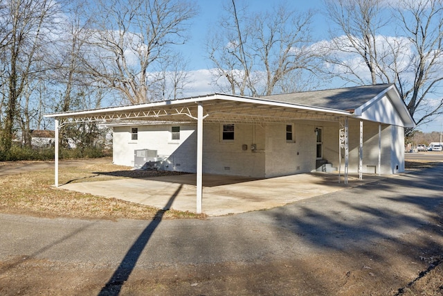 exterior space featuring cooling unit and a carport