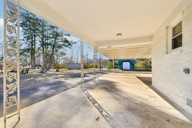 view of patio with a storage unit