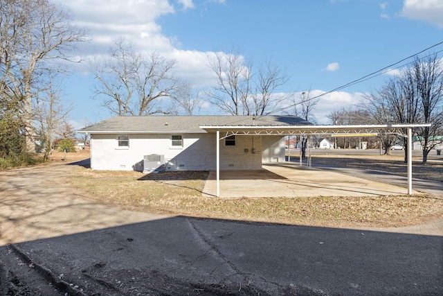 exterior space with central AC and a carport