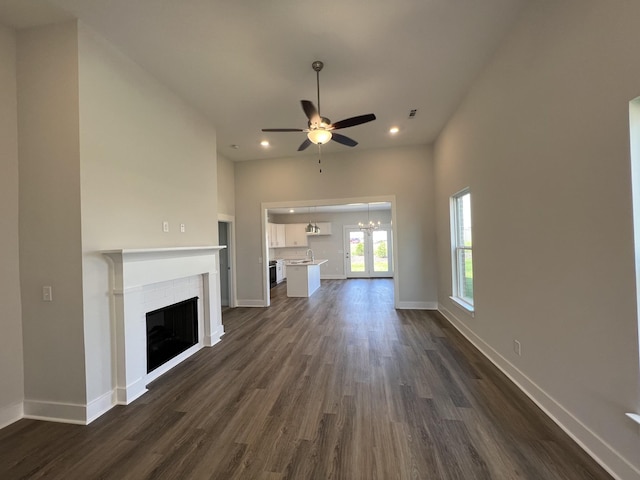 unfurnished living room with ceiling fan, dark wood-type flooring, and sink