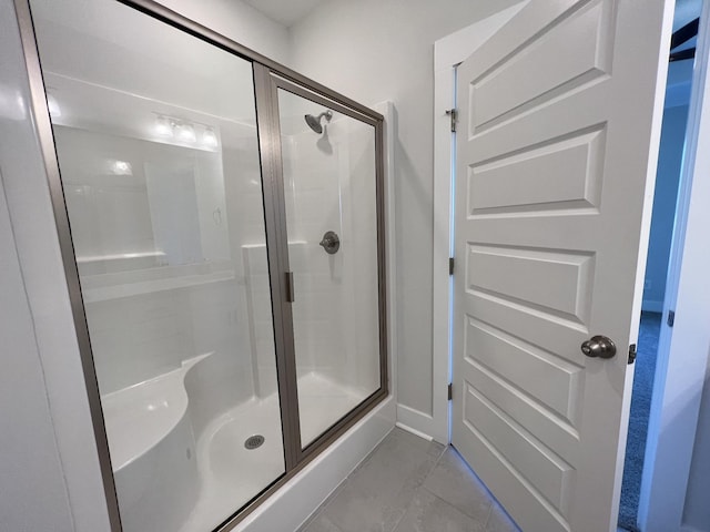 bathroom featuring walk in shower and tile patterned flooring